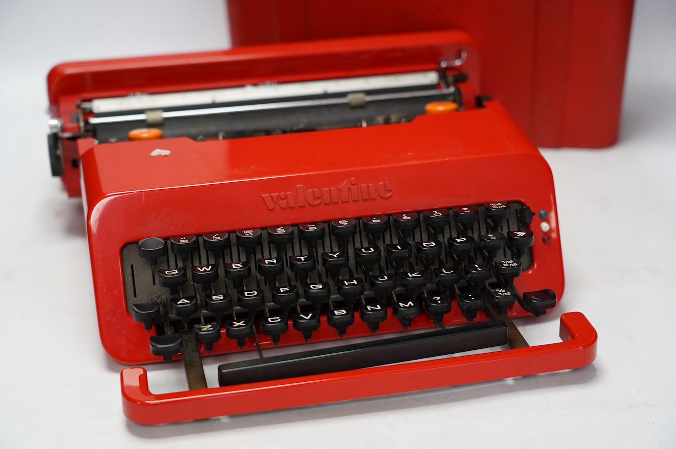 An Olivetti Valentine portable typewriter, designed by Ettore Sottsass & Perry, in its case. Condition - fair, some wear and scuffing to the plastic body and case